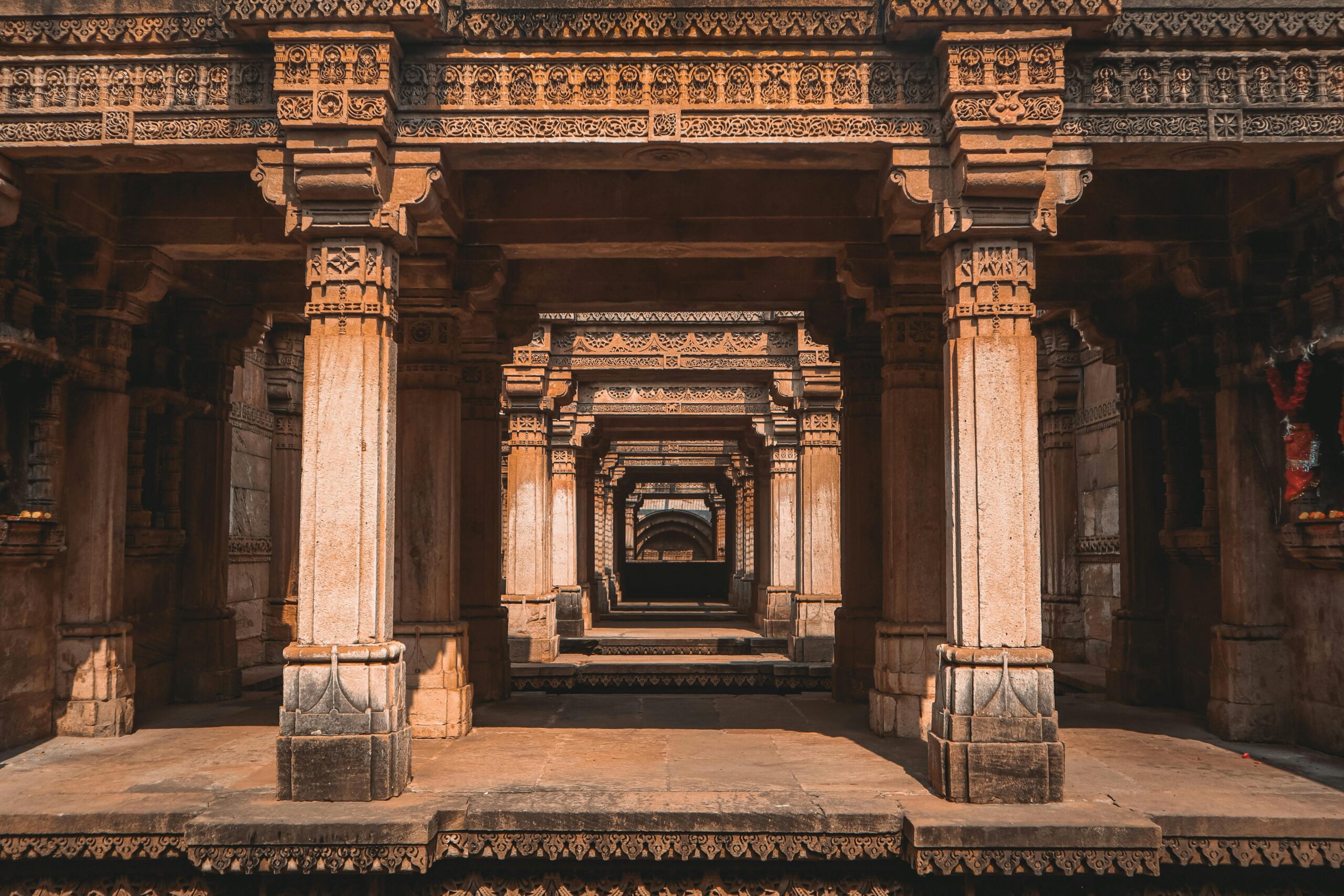 Explore the ornately carved columns of Adalaj Stepwell in Gujarat, India.
