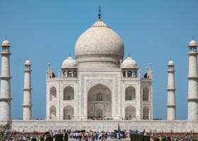 A captivating view of the Taj Mahal under a clear blue sky, showcasing its iconic architecture.